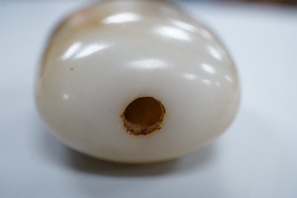 A 19th century Chinese white and russet jade pebble snuff bottle, 5.5cm in length
